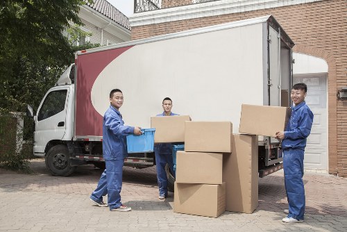 Moving team preparing boxes and equipment with safety awareness