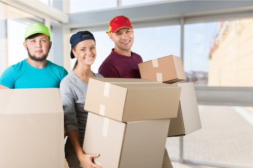 Professional movers carrying furniture during a Pinner relocation