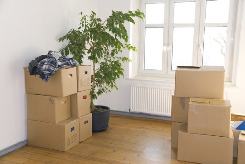 Packed boxes and furniture ready for collection in a Pinner home