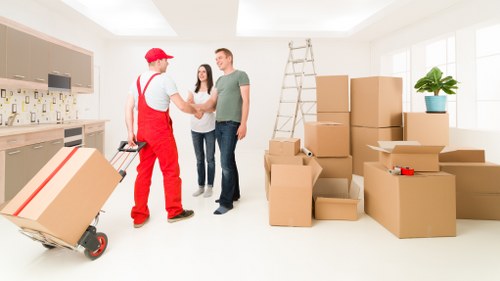 Removal team handling furniture and boxes for a local Pinner home move